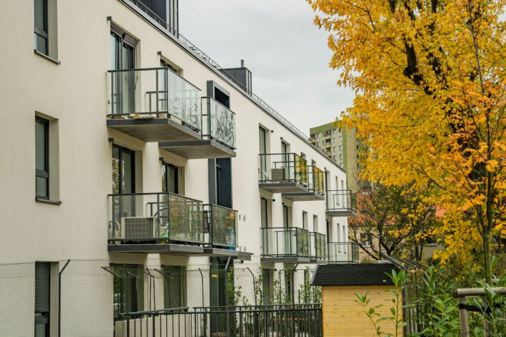 The Art of Drawing Readers In: Your attractive post title goes here Contemporary apartment building with balconies and autumn leaves enhancing the urban scenery.